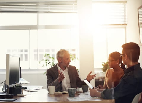 Shot of a group of coworkers in a boardroom meeting.