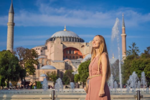 Woman enjoy beautiful view on Hagia Sophia Cathedral, famous islamic Landmark mosque, Travel to Istanbul, Turkey. Sunny day architecture and Hagia Sophia Museum, in Eminonu, istanbul, Turkey. Turkiye.