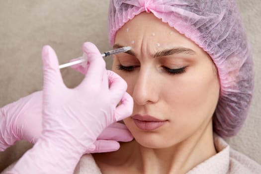 Cosmetologist performs the lift procedure by injecting beauty injections. Doctor injecting hyaluronic acid as a facial rejuvenation treatment