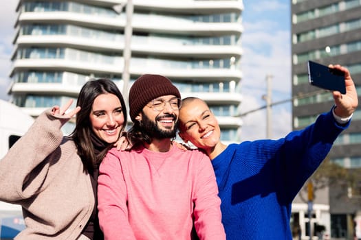 three smiling friends taking a selfie photo in the city, concept of friendship and urban lifestyle, copy space for text