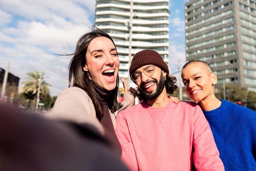 selfie photo of three smiling friends having fun in the city, concept of friendship and urban lifestyle