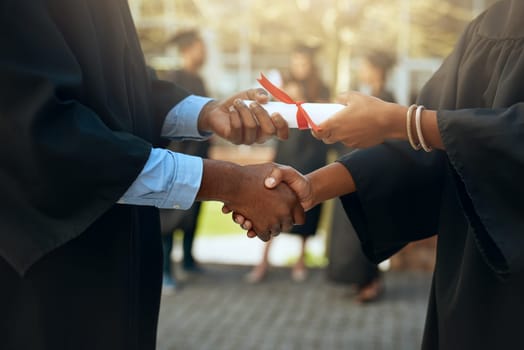 Handshake, graduation and hands with certificate at a college for education or scholarship. Support, thank you and a university graduate shaking hands with a teacher for certification and achievement.