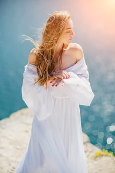 Portrait of a blond woman at the sea, a woman makes photos for memory from a trip to the sea to show to friends