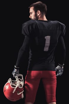 Soccer player on a dark background in vintage style. The classic American game. college Students