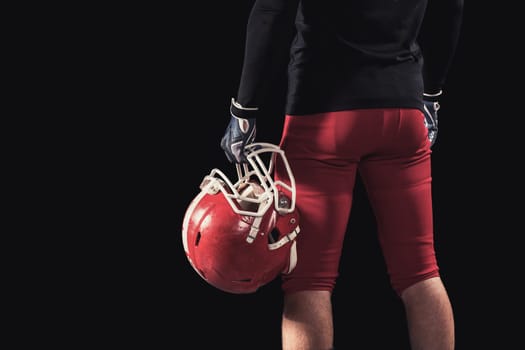 Soccer player on a dark background in vintage style. The classic American game. college Students. close-up helmet