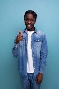 close-up portrait of a cool fashionable african guy with dreadlocks in a denim jacket with insight.