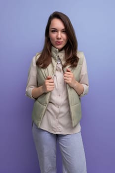 well-groomed caucasian brunette young lady in casual style on studio background.