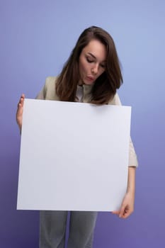 young brunette woman demonstrating a paper board with mockup.