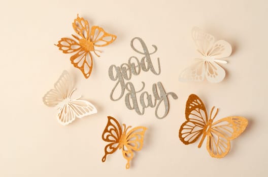 Good day text with butterfly paper carve on pastel background.