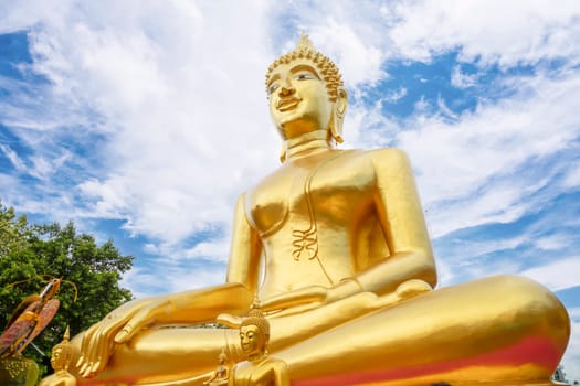 Golden Big Buddha with blue sky in Pattaya, Thailand in a summer day