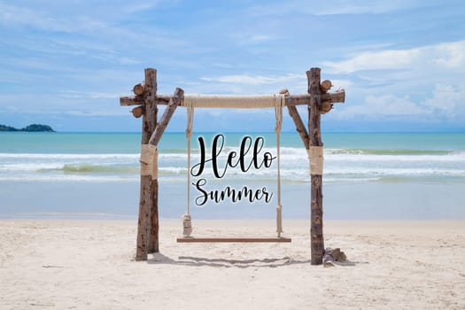 Hello Summer. Sandy beach and wooden swing on sunny day