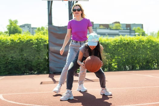 Mother and little daughter after basketball. Great job honey