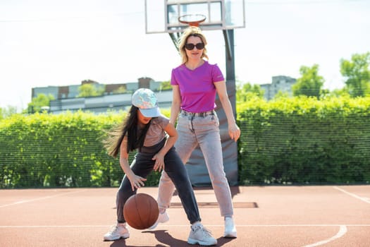 Mother and daughter playing basketball