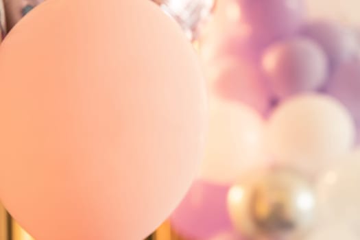 Pink color balloons festive background with copy space, selective soft focus.