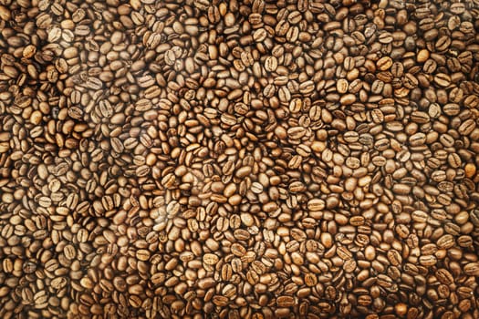 Background of brown roasted coffee beans, top view texture.