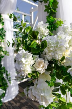 Luxury elegant beautiful wedding summer decoration with flowers outdoor, vertical.