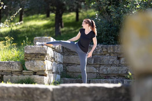 Fitness concept - adult woman does stretching. Mid shot