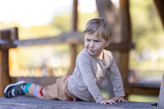 Funny little boy on playground. Mid shot