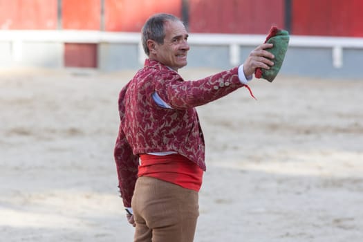 March 26, 2023 Lisbon, Portugal: Tourada - elderly forcado standing on arena with blood on his face. Mid shot