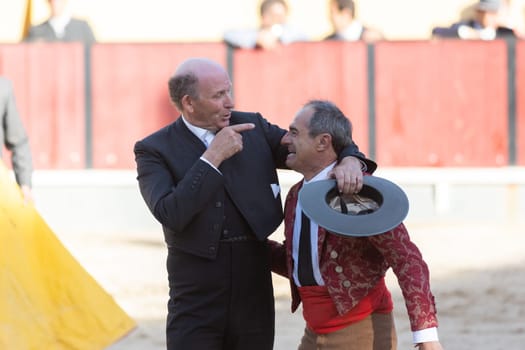 March 26, 2023 Lisbon, Portugal: Tourada - elderly forcado and cavaleiro on the arena. Mid shot