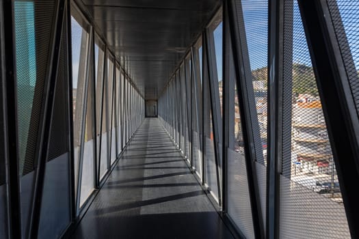 Walking on modern bridge in european town - a person's POV. Mid shot