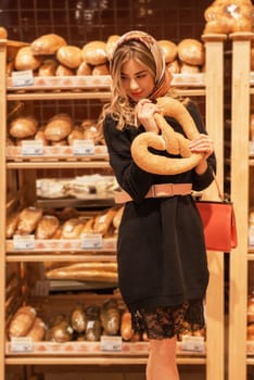 The young pretty woman in the bread depatment at the supermarket