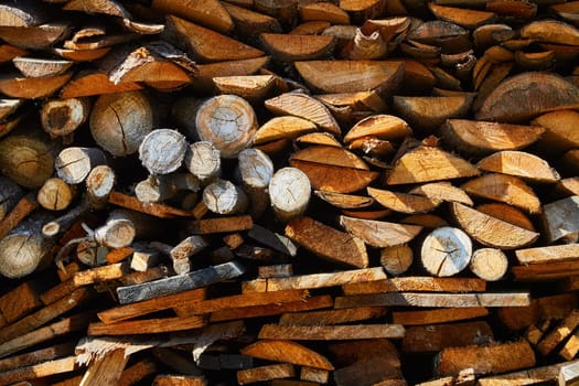 Old tree, logs, firewood harvested for the winter for heating season. Beautiful background with texture of wooden boards close-up. Abstract photo