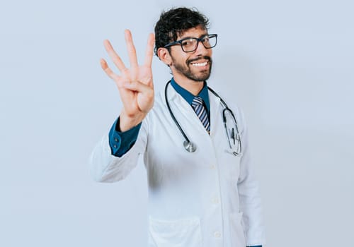 Doctor counting number four isolated. Handsome doctor counting number 4 on isolated background.