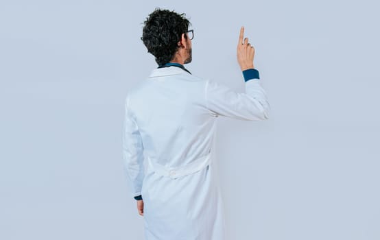 Doctor posing from back pointing finger. Young doctor from back pointing finger isolated.