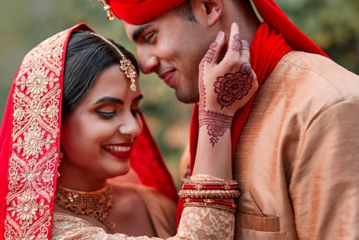 Wedding, marriage and hand henna with couple together in celebration of love at a ceremony. Happy, romance or islamic with a husband and wife getting married outdoor in tradition of their culture.