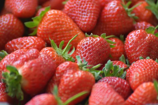 Background of an appetizing ripe large strawberries
