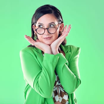 Woman, teacher and hands on face with green screen, studio background and thinking with vision for career. Young model, education and ideas with glasses, mockup and with fashion, pride and happiness.