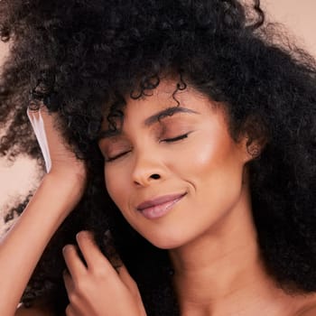 Beauty, hair and skincare of black woman in studio for self care with shampoo and cosmetics. Face of aesthetic model person with natural afro and facial makeup glow or shine for health and wellness.