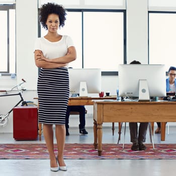 Im here to get the job done. Portrait of a confident young professional standing with her arms crossed in an office