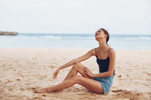 beach woman model travel vacation natural freedom sitting sun smile tropical coast young hair white relax sand nature view carefree back sea