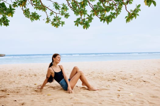 woman carefree freedom beautiful fashion sea relax ocean travel nature alone lifestyle sitting vacation summer smile holiday sand bali beach water