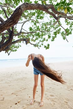 woman beautiful fitness holiday sea ocean smiling female paradise vacation happy hanging nature happiness tree sky lifestyle sitting fool young relax