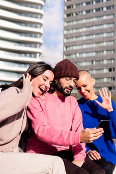 three young friends filming with phone a video of memories for social media, concept of friendship and fun with technology of communication, copy space for text