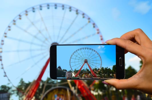 Girl photographing the attractions from your phone