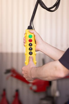 Yellow lift control panel in the auto service