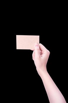 Young asia clean girl hand holding a blank kraft brown paper card template isolated on black background, clipping path, close up, mock up, cut out