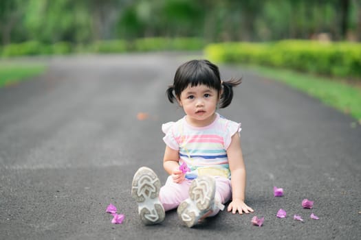Cute baby sitting at the garden, cute baby outdoor activity concept