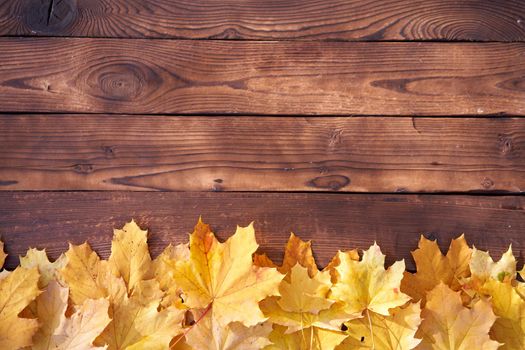 Autumn leaves frame on wooden background top view Fall Border yellow and Orange Leaves vintage wood table Copy space for text