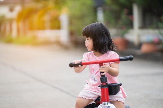 cute baby crying and riding bicycle