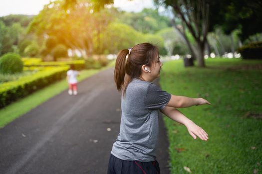 beautiful women streching before running at the park