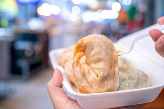 Delicious steamed round shaped dumplings in South Korea traditional market, special korean street food cuisine, close up, bokeh, copy space