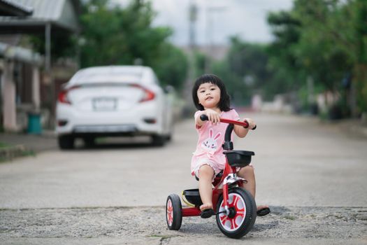 Cute children riding a bike. Kids enjoying a bicycle ride.