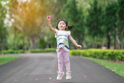 Cute baby playing and jomping at the garden, cute baby outdoor activity concept