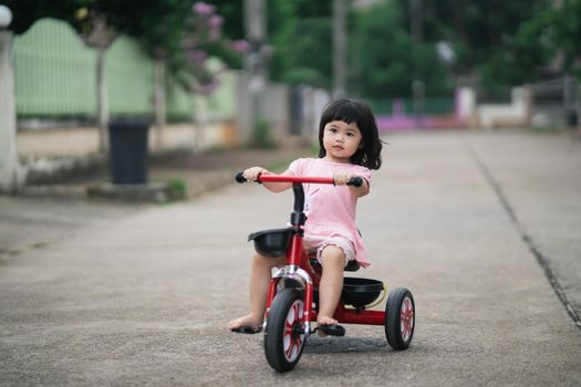 Cute children riding a bike. Kids enjoying a bicycle ride.