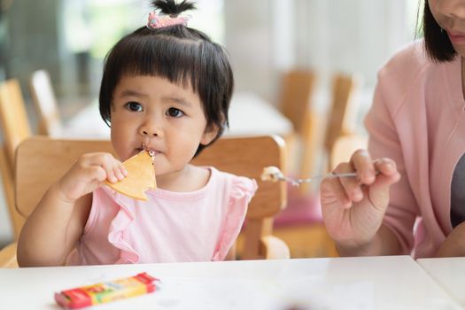 cute baby eating ice cream on the table in the restaurant